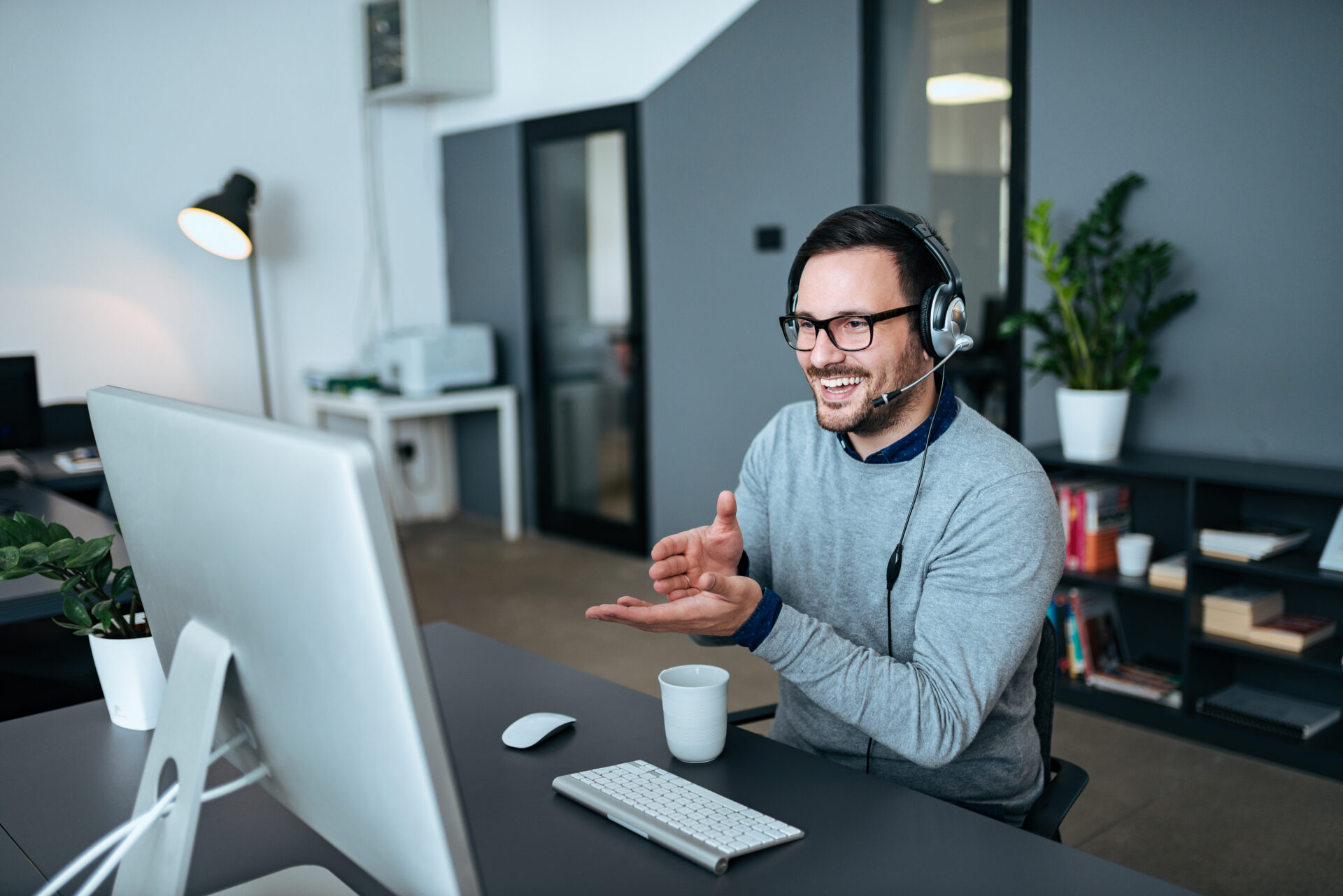 Handsome young man having online call at modern office.